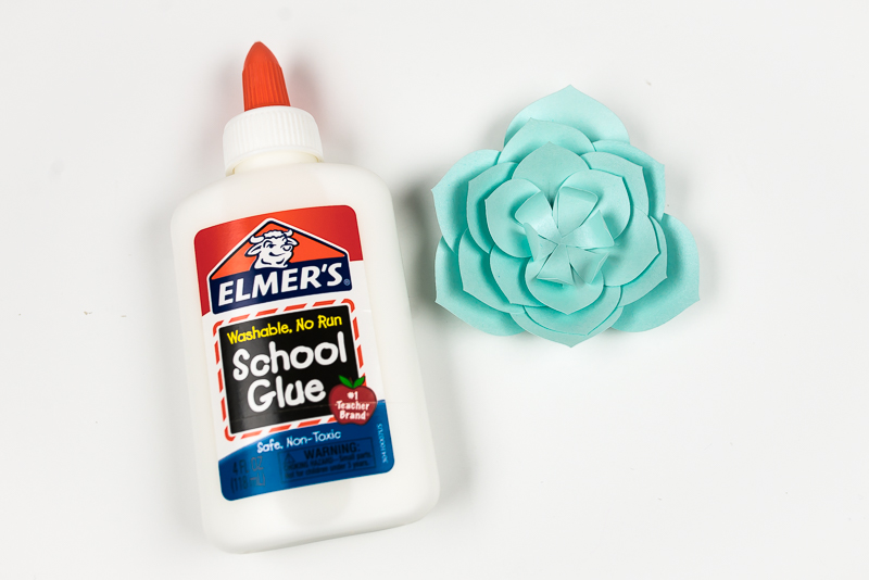 Elmer’s school glue and several layers of an aqua colored paper succulent assembled